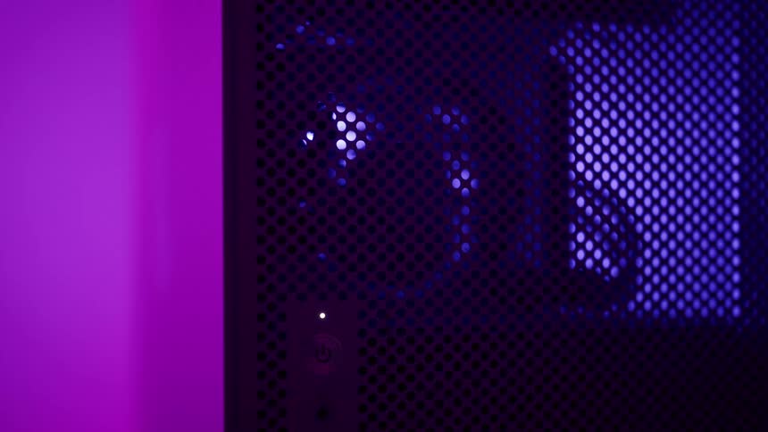Fan spins behind black mesh and room lights change color