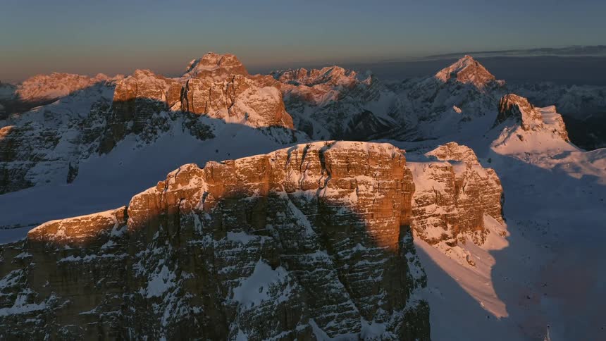 A snowy mountain ridge in the evening