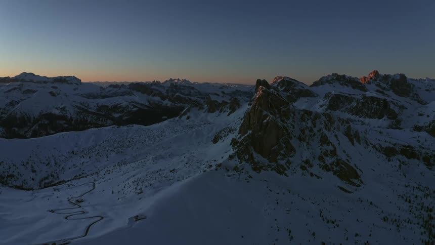 Snow covered mountains with peaks high in a clear sky