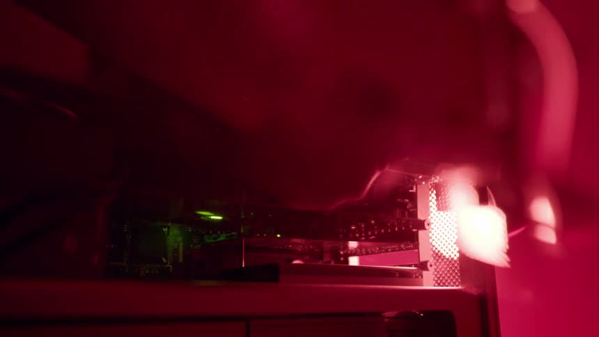 Person insert cartridge into machine as colored lights change color