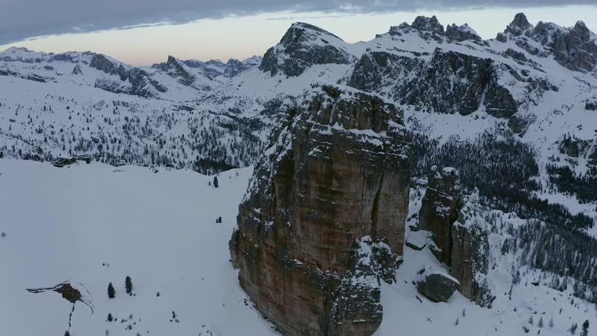 The mountain range is covered with snow and trees