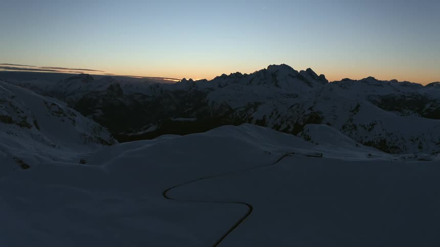 Snow is covering the mountain range at dawn