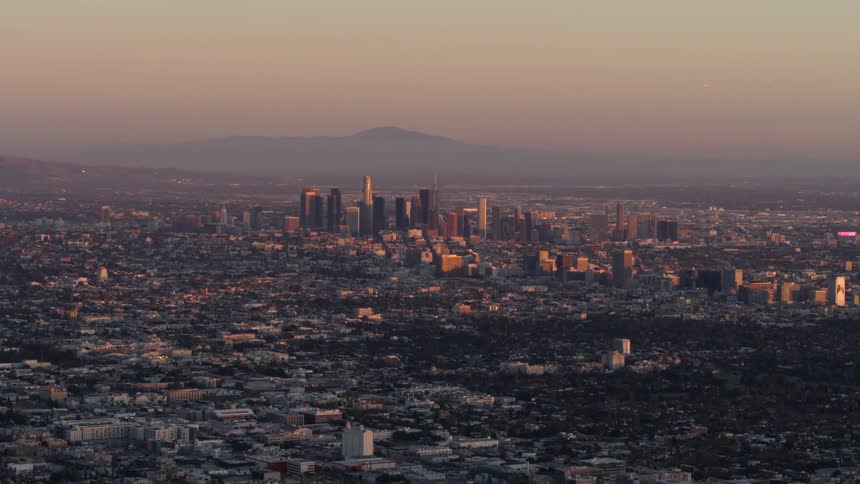 A golden hour view of the downtown LA skyline and urban sprawl