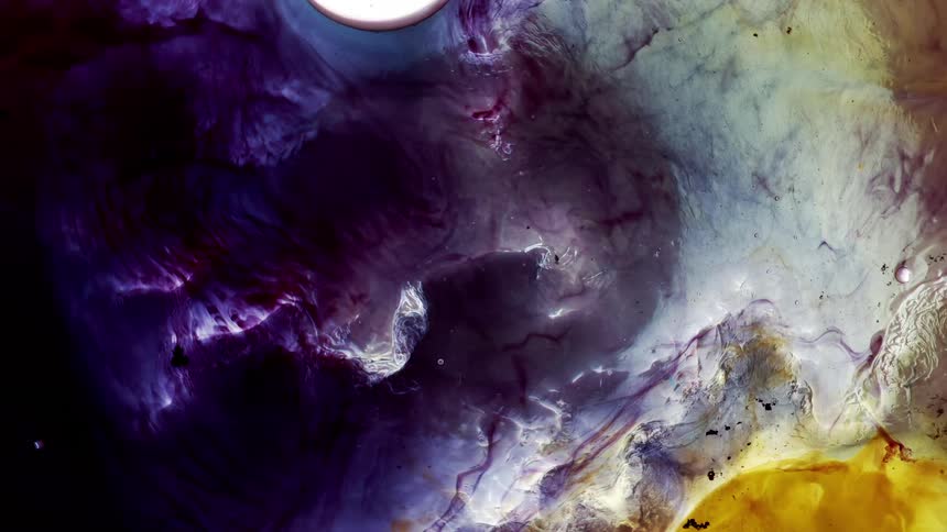 Water flowing over a colorful shimmering violet purple yellow background