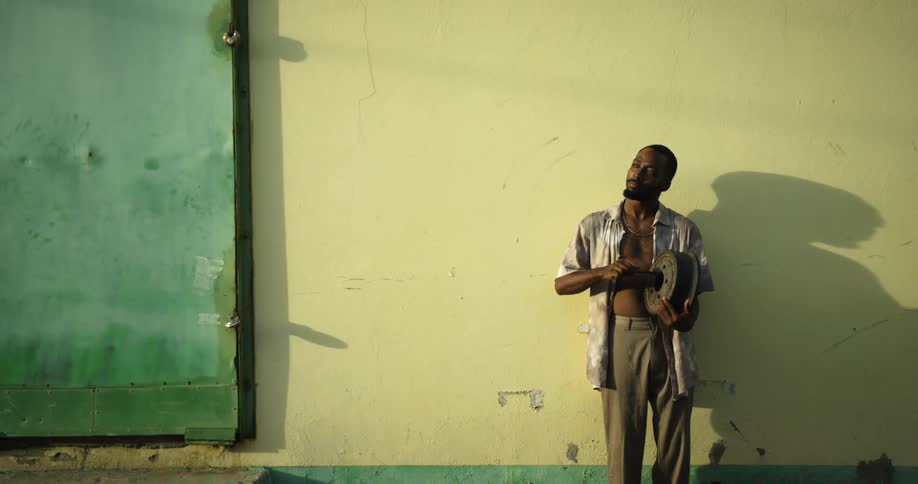 A man standing by a wall