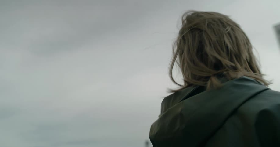 A woman is looking around at the buildings