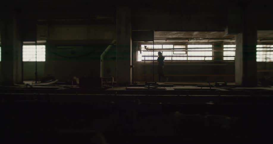 A woman walking in an abandoned building