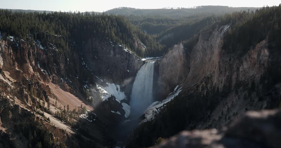 A waterfall in a mountain valley during the day