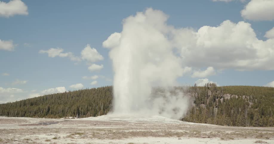 Old Faithful geyser hot spring erupting jets of water and steam into the air