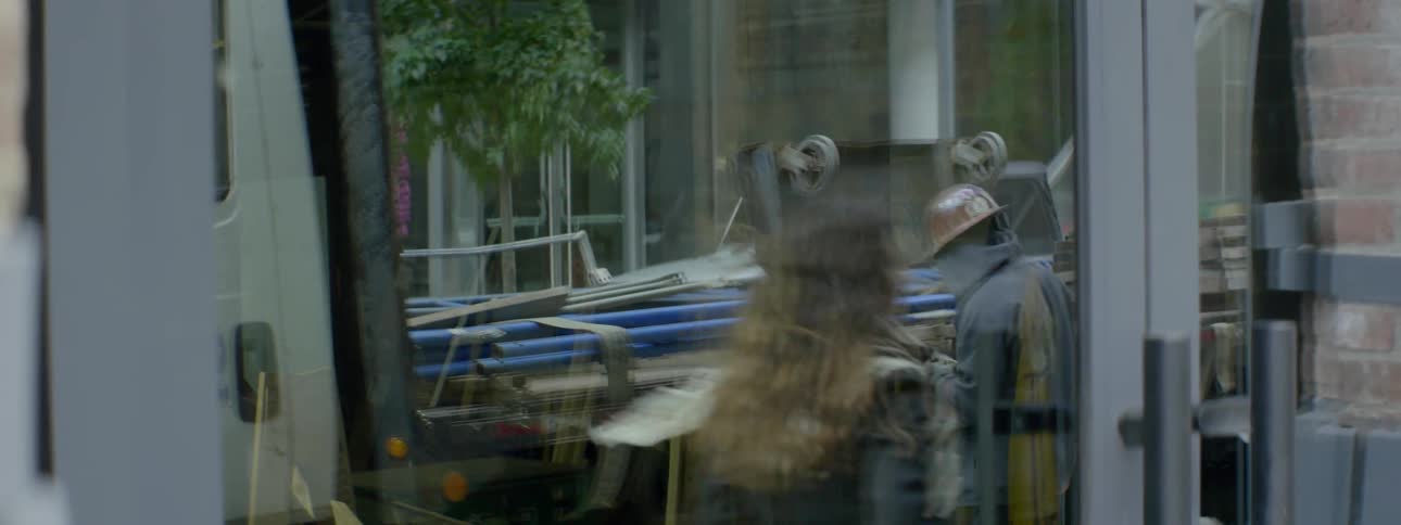 People are reflected in a store window