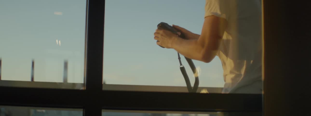 A man takes photographs out of a window