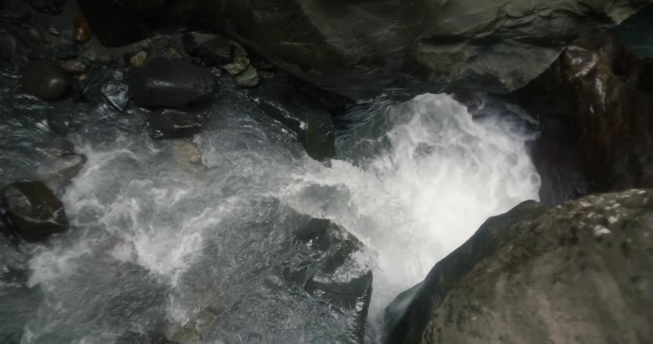 The water pours down the large boulders