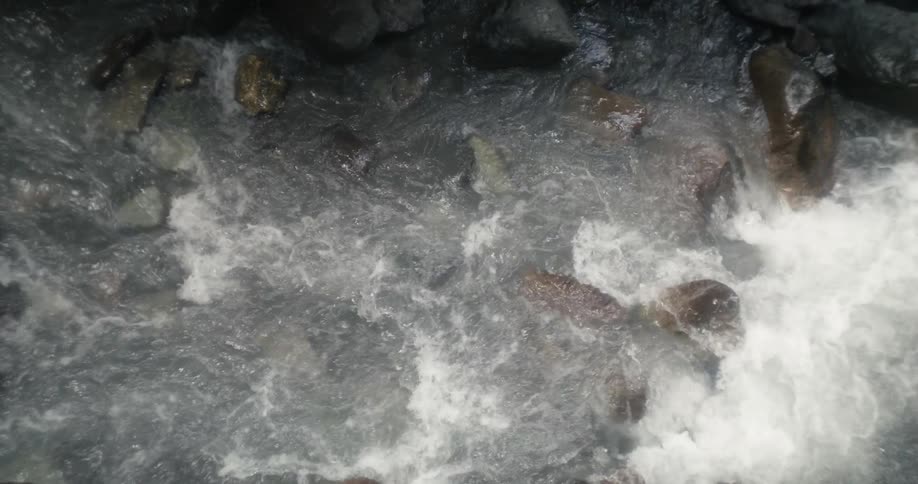 Clear river water flowing over the rocks downstream