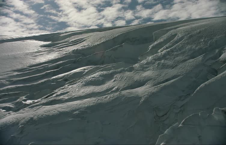 Aerial view of snow and ice over the mountain slopes at daytime