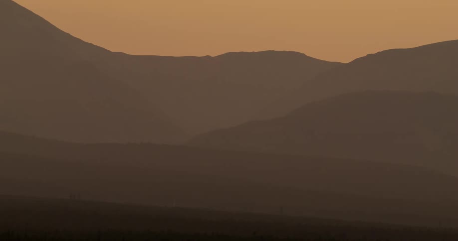Blowing sand creates a dusty haze in the desert