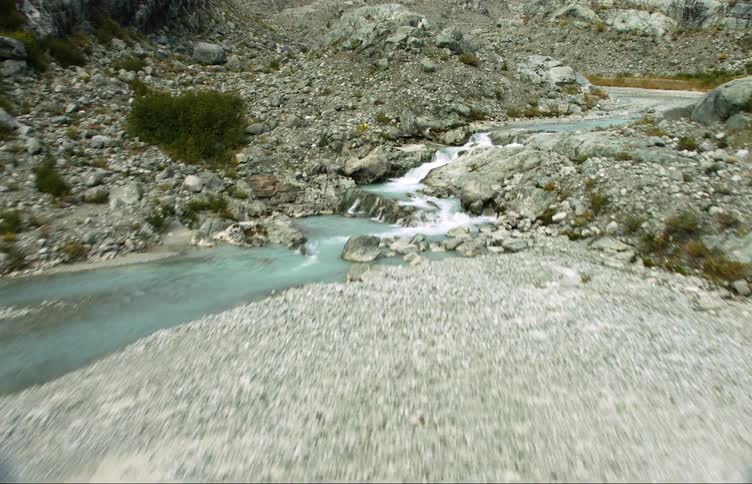 Aerial view of streams flowing from a river coming down a mountain