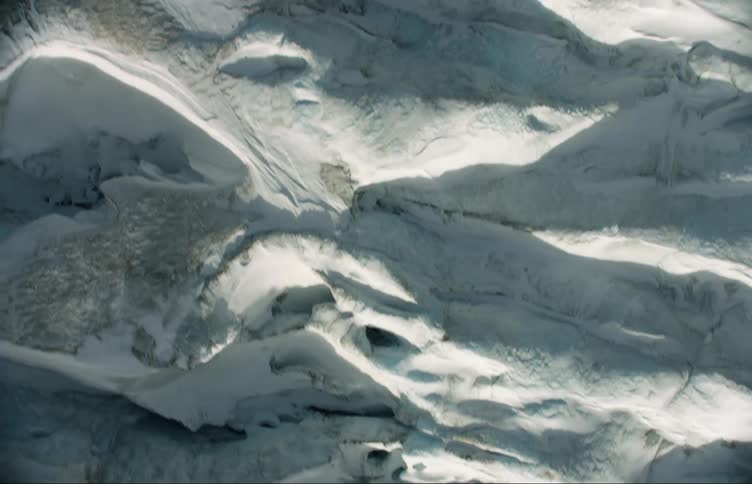 Shadows and light dapple crevices in ice