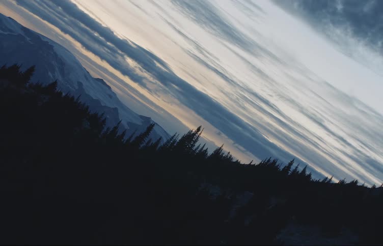The sun is setting on the mountain range