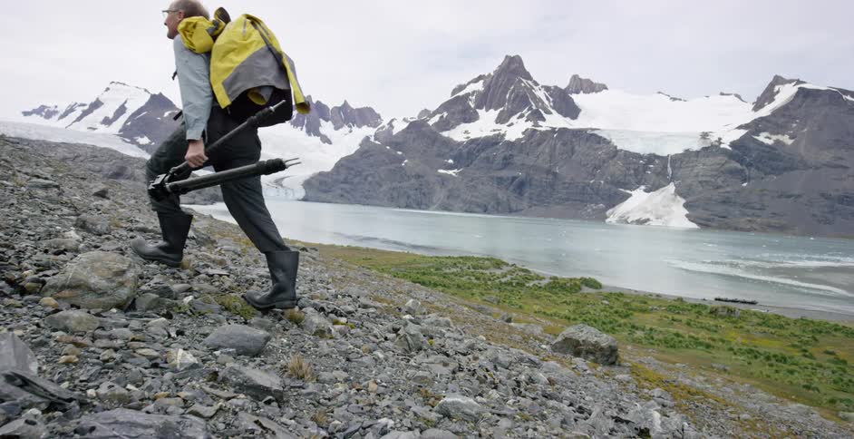 A man hikes up a rocky path