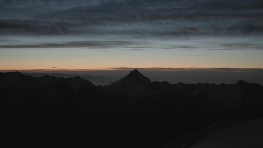 The mountains are dark at sunset
