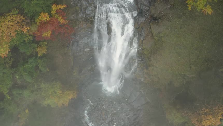 The waterfall is pouring down from the cliff