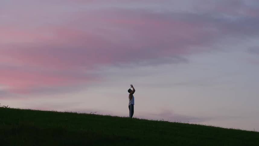 Silhouette of a man doing tai chi movements