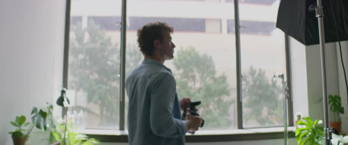 A man walks in his studio and flashes a picture