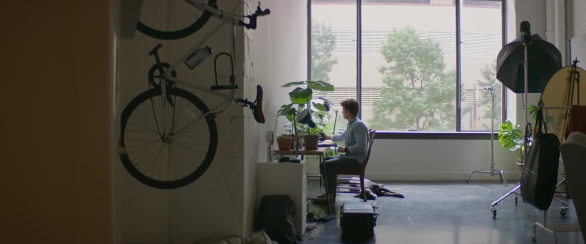 A man sitting at a table and looking at a camera