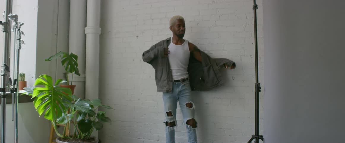 Model moves through a series of poses as camera flashes