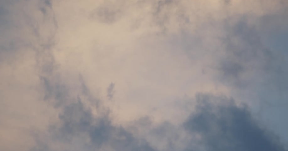Cumulus clouds flow across blue sky