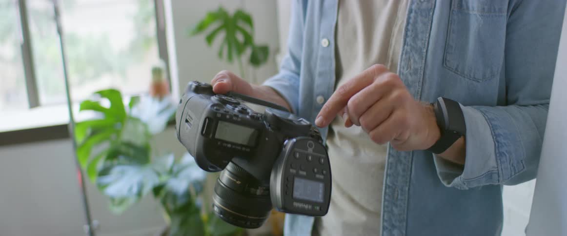 Two men look at photos on a camera