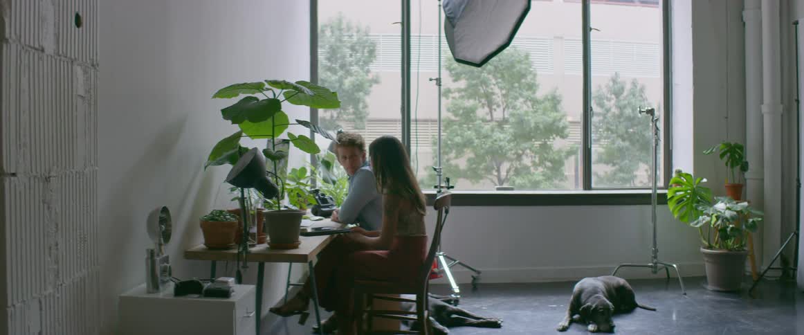 Two people sitting and talking at a desk