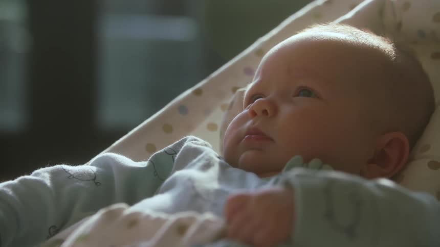 A baby is resting under the sunlight