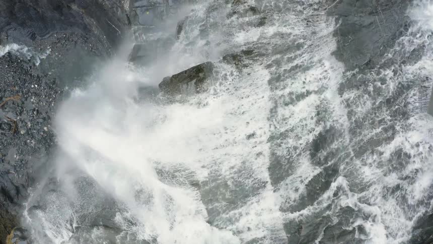 A waterfall plunges over a steep cliff