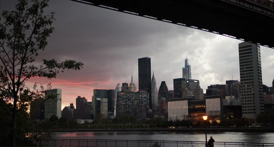 A person is watching the city at sunrise