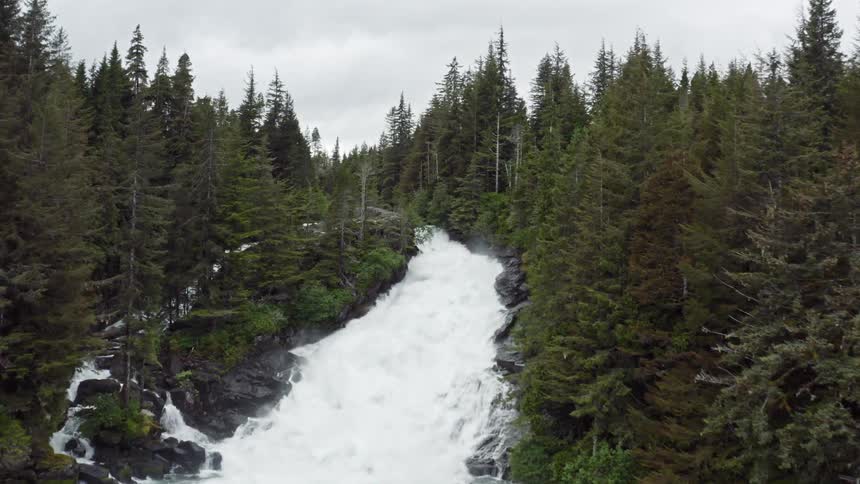 Raging rapids fall into the lake by the cabin