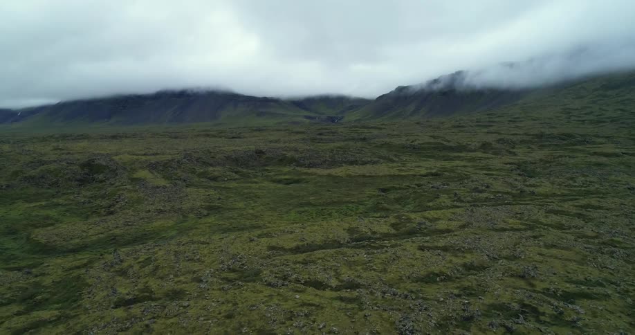 Clouds cover the top of a mountain ridge