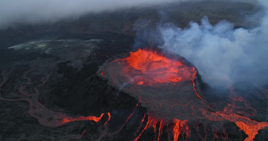Lava is bubbling and gushing out of a volcano