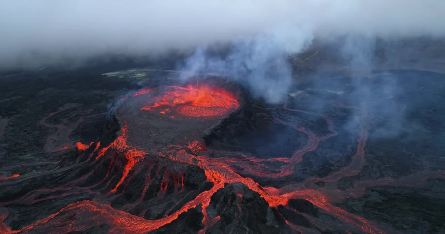 An aerial view of a mountain with lava flowing
