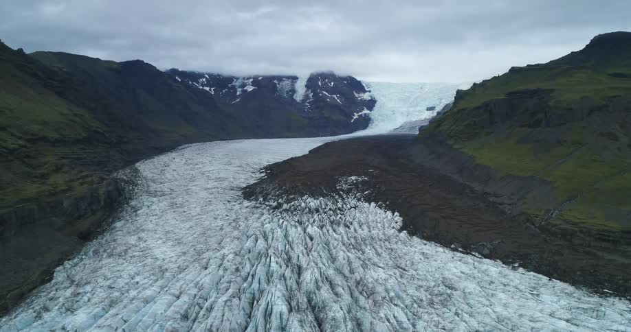 An aerial view of a glacier in the mountains