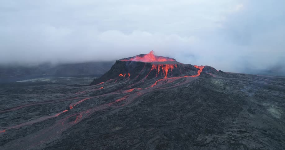 A volcano is erupting with lava pouring all over