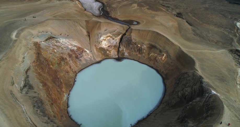 An aerial view of a lake in the middle of a crater