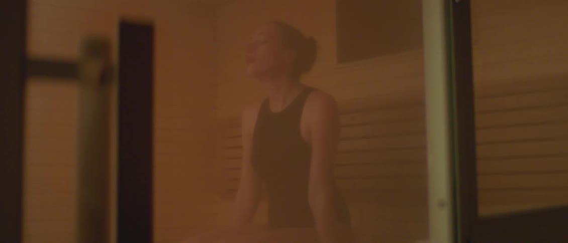 A woman sitting in a sauna