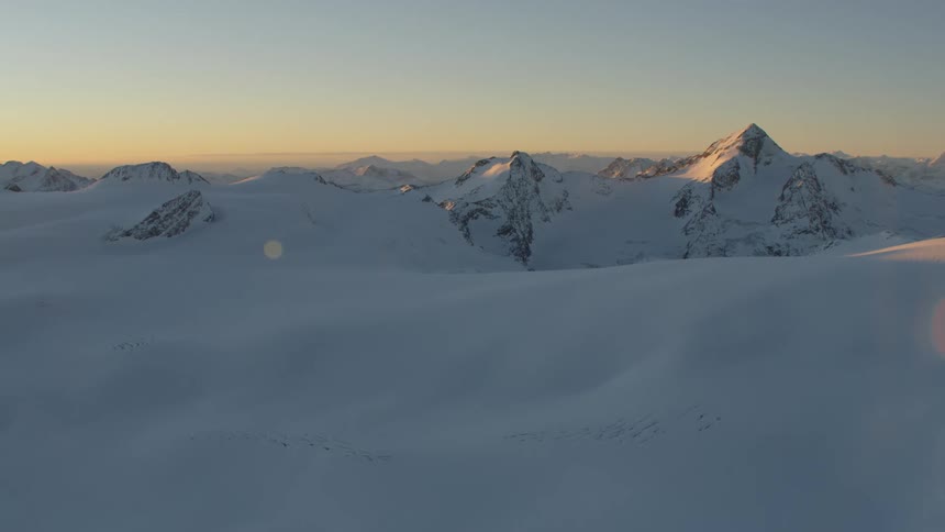 The large mountain range has heavy snow all over