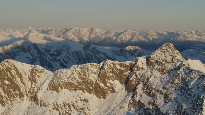 A snowy mountain ridge during the day