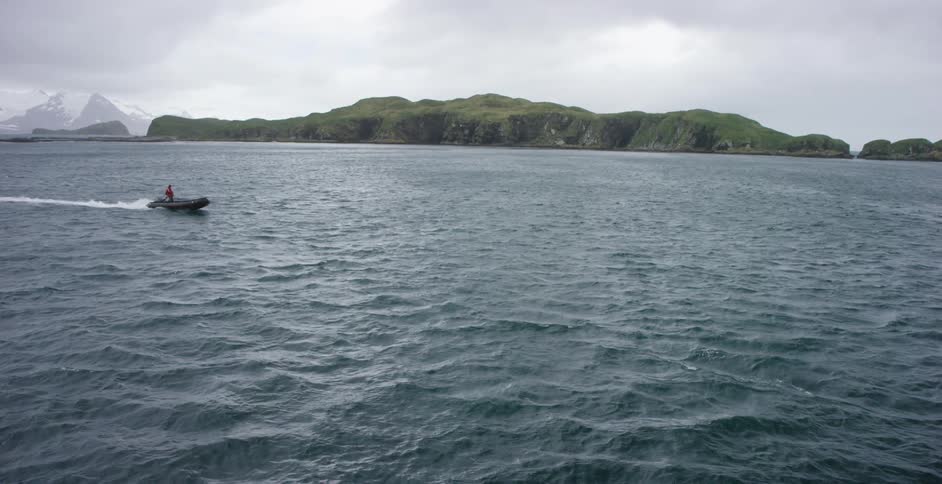 Small boat moving across a large body of water