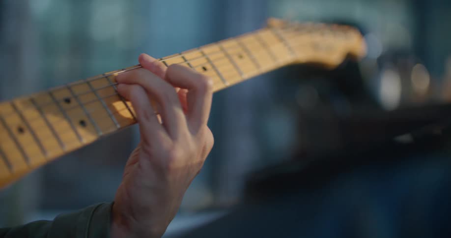 Man sits playing guitar