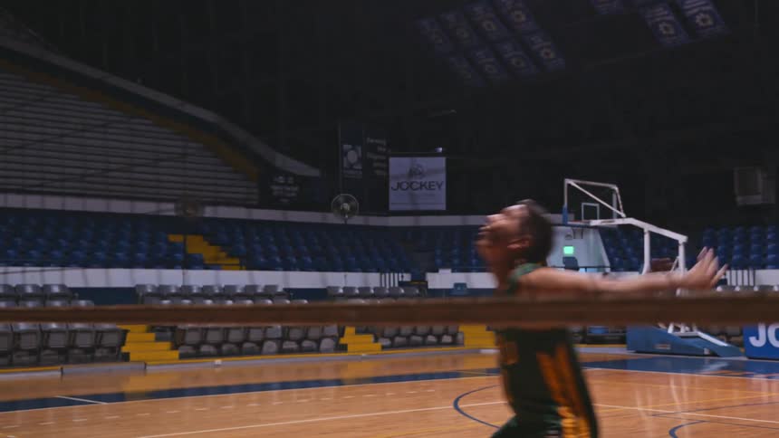 A man practicing a serve for volleyball