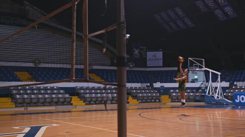 A man practicing his volleyball serve