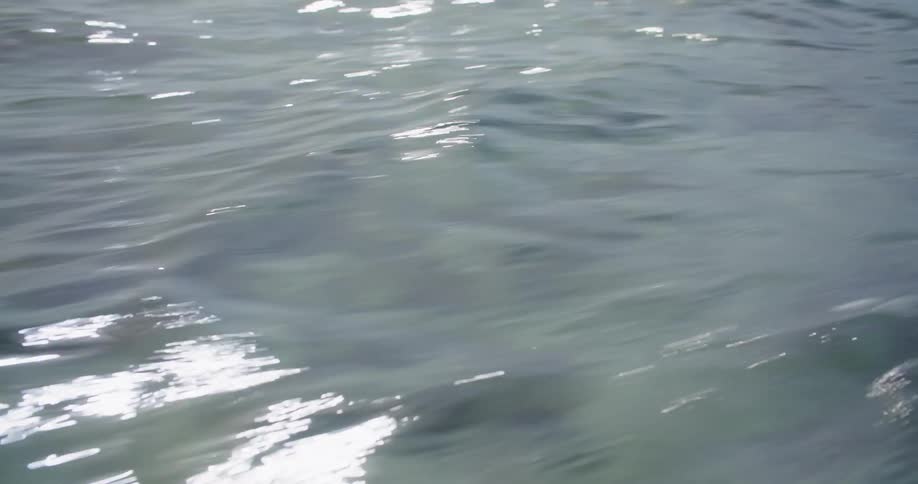 The ocean rippling and waving from a boat
